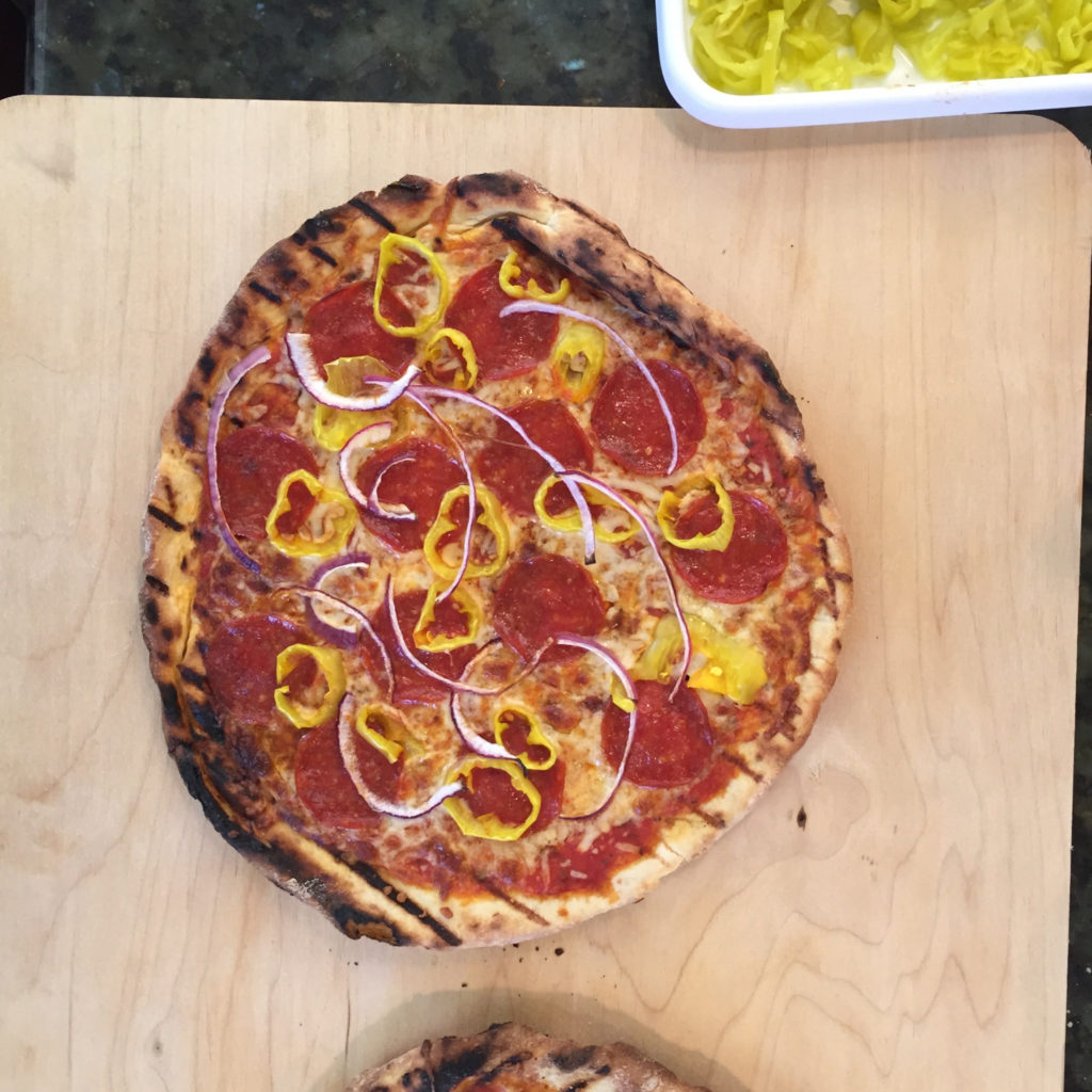 Grilled pizza topped with Sliced Golden Greek Peperoncini, light cheese and thinly sliced red onions. 